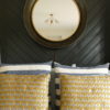 gold bee design cushions against black wall with mirror
