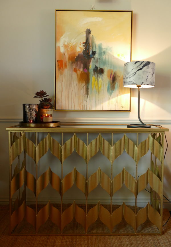 sassy gold console table with abstract painting and lamp sold by stagers lifestyle