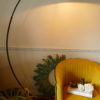 half moon floor lamp and Velvet mustard chair and large iron lamp turned on