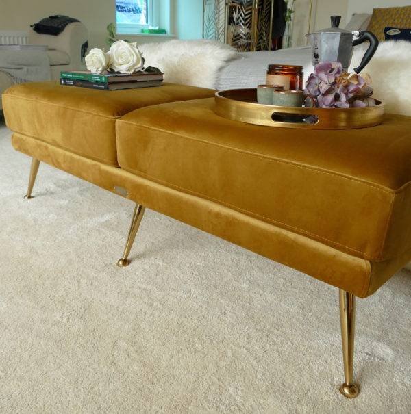 mid century mustard ottoman at the end of bed with tray